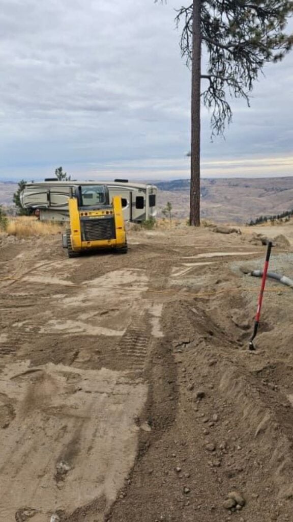 freshly graded lot with trailer in background