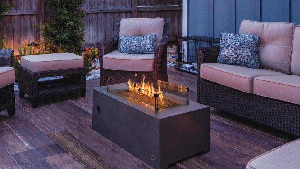 an outdoor seating area with a custom gas fireplace