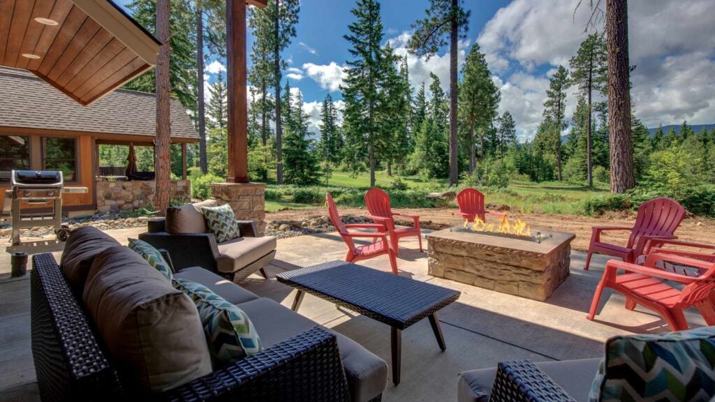 an outdoor seating area with a custom gas fireplace