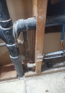plumbing exposed behind wall