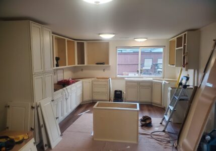 kitchen cabinets being installed with tools present
