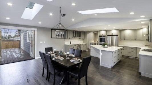 a full kitchen remodel with white counters and cabinets