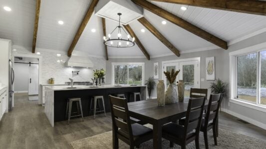 wide angle photo of kitchen and dining area