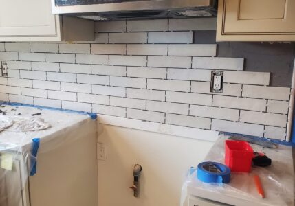 Backsplash tiles being installed